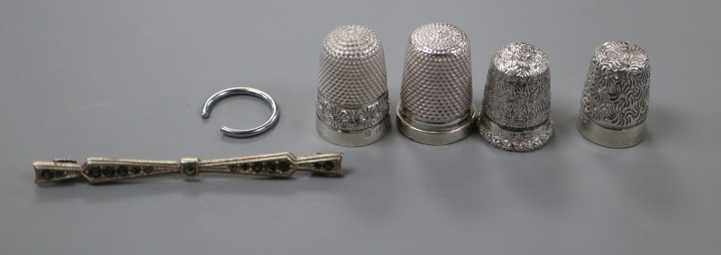 Four silver thimbles including two Charles Horner and a sterling and marcasite brooch.
